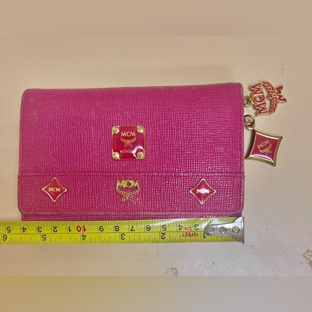 Preowned Authentic MCM beautiful trifold short studded leather wallet.
